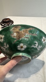 A Chinese verte biscuit 'animals among waves' bowl and a wooden stand, Jiajing mark, Kangxi