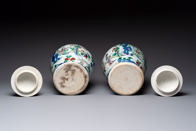 A pair of Chinese wucai vases and covers with court ladies and playing boys, Transitional period
