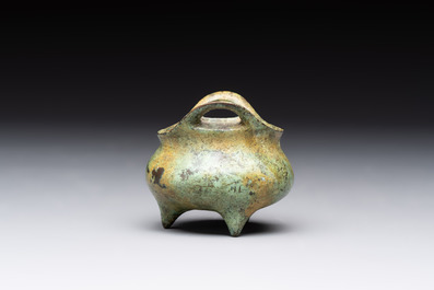 A Chinese bronze tripod censer with cover and stand, a small tripod censer and a silver-inlaid iron brush pot, 19/20th C.
