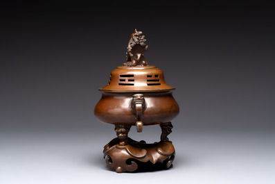 A Chinese bronze tripod censer with cover and stand, a small tripod censer and a silver-inlaid iron brush pot, 19/20th C.