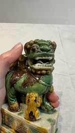 A pair of Chinese sancai-glazed Buddhist lions and an inkwell, 19th C.