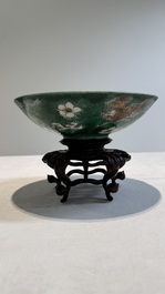 A Chinese verte biscuit 'animals among waves' bowl and a wooden stand, Jiajing mark, Kangxi