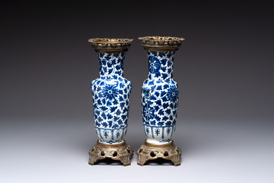 A pair of Chinese blue and white bronze-mounted vases and a covered jar, 19th C.