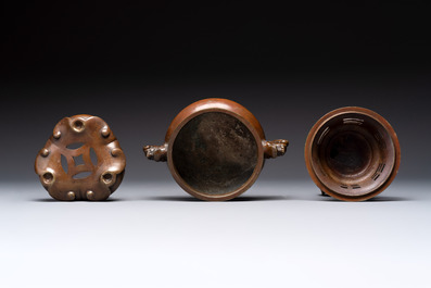 A Chinese bronze tripod censer with cover and stand, a small tripod censer and a silver-inlaid iron brush pot, 19/20th C.