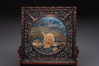 A Chinese wooden table screen with an embroidered silk with turtle design, 19th C.