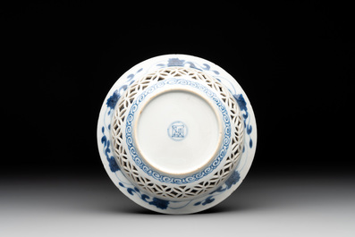 A Chinese blue and white reticulated double-walled cup and saucer, fu mark, Kangxi