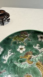 A Chinese verte biscuit 'animals among waves' bowl and a wooden stand, Jiajing mark, Kangxi