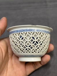 A Chinese blue and white reticulated double-walled cup and saucer, fu mark, Kangxi