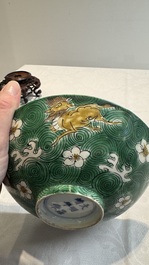 A Chinese verte biscuit 'animals among waves' bowl and a wooden stand, Jiajing mark, Kangxi
