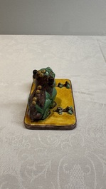 A pair of Chinese sancai-glazed Buddhist lions and an inkwell, 19th C.