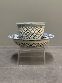 A Chinese blue and white reticulated double-walled cup and saucer, fu mark, Kangxi