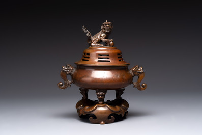A Chinese bronze tripod censer with cover and stand, a small tripod censer and a silver-inlaid iron brush pot, 19/20th C.