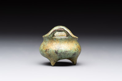 A Chinese bronze tripod censer with cover and stand, a small tripod censer and a silver-inlaid iron brush pot, 19/20th C.