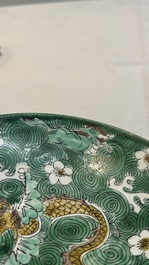 A Chinese verte biscuit 'animals among waves' bowl and a wooden stand, Jiajing mark, Kangxi