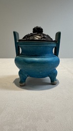 A Chinese turquoise-glazed tripod censer with wooden cover, Ming