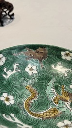A Chinese verte biscuit 'animals among waves' bowl and a wooden stand, Jiajing mark, Kangxi