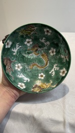 A Chinese verte biscuit 'animals among waves' bowl and a wooden stand, Jiajing mark, Kangxi