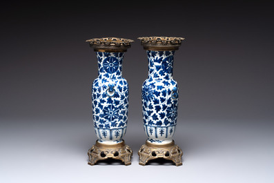 A pair of Chinese blue and white bronze-mounted vases and a covered jar, 19th C.