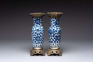 A pair of Chinese blue and white bronze-mounted vases and a covered jar, 19th C.