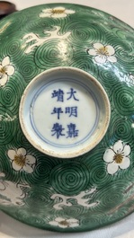 A Chinese verte biscuit 'animals among waves' bowl and a wooden stand, Jiajing mark, Kangxi