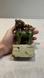 A pair of Chinese sancai-glazed Buddhist lions and an inkwell, 19th C.