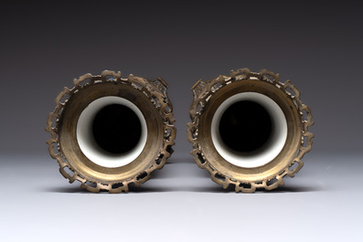 A pair of Chinese blue and white bronze-mounted vases and a covered jar, 19th C.