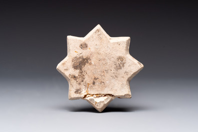 A polychrome Kashan relief-moulded star-shaped tile with herons, Persia, 14th C.