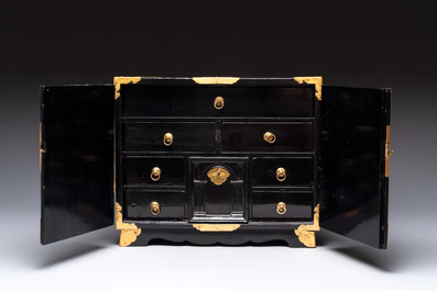 A rare Japanese black-lacquered cabinet with finely engraved gilt mounts, Edo, late 17th C.