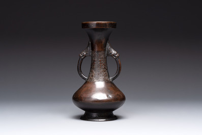 A Chinese archaistic bronze vase and three Japanese bronze vases, 14/18th C.