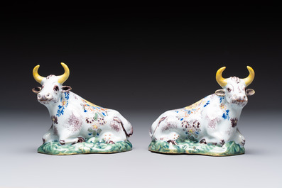 A pair of polychrome Dutch Delft reclining cows, 18th C.