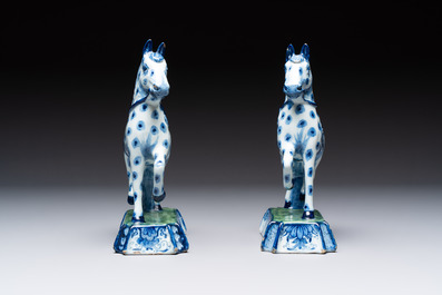 A pair of blue and white Dutch Delft prancing horses on a green-glazed base, 18th C.