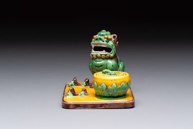 A pair of Chinese sancai-glazed Buddhist lions and an inkwell, 19th C.