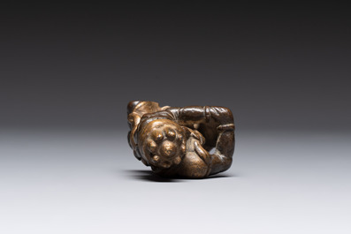 A small Chinese gilt bronze paperweight in the form of a kneeling foreigner, Ming