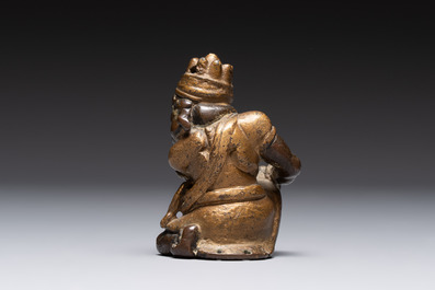 A small Chinese gilt bronze paperweight in the form of a kneeling foreigner, Ming