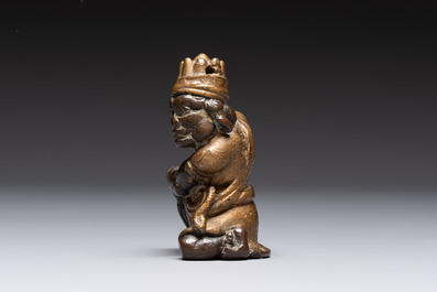 A small Chinese gilt bronze paperweight in the form of a kneeling foreigner, Ming