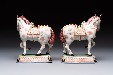 A pair of polychrome and gilt-decorated Dutch Delft petit feu horses, 18th C.