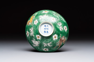 A Chinese verte biscuit 'animals among waves' bowl and a wooden stand, Jiajing mark, Kangxi