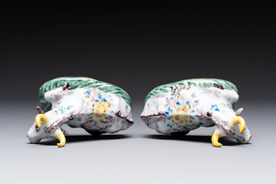 A pair of polychrome Dutch Delft reclining cows, 18th C.