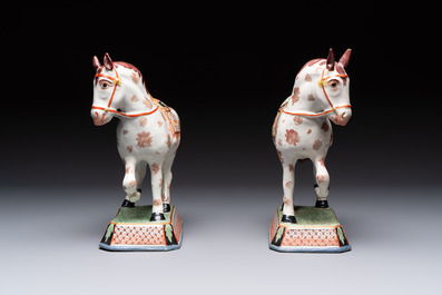 A pair of polychrome and gilt-decorated Dutch Delft petit feu horses, 18th C.