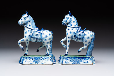 A pair of blue and white Dutch Delft prancing horses on a green-glazed base, 18th C.