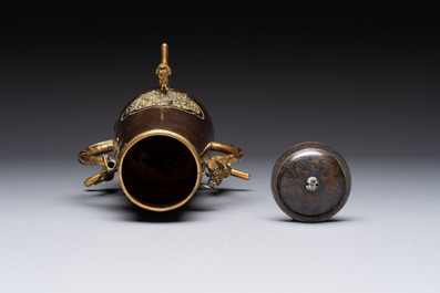 A rare and fine Chinese partly-gilt copper chocolate pot with tripod stand, 18th C.
