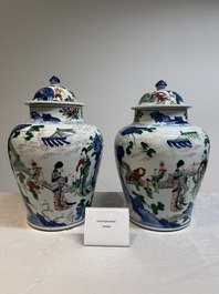 A pair of Chinese wucai vases and covers with court ladies and playing boys, Transitional period