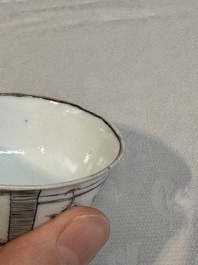 Two Chinese gilt-decorated grisaille 'European subject' cups and saucers, Qianlong