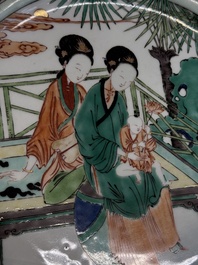 A Chinese famille verte dish with two ladies and a boy holding a lotus, artemisia leaf mark, Kangxi