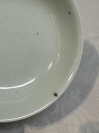 A Chinese monochrome 'anhua' 'dragon' bowl and a blue and white 'dragon' saucer, 18/19th C.
