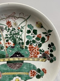 Two Chinese famille verte 'flower basket' dishes and a plate, Kangxi