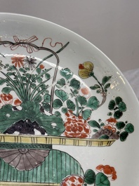 Two Chinese famille verte 'flower basket' dishes and a plate, Kangxi