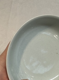 A Chinese monochrome 'anhua' 'dragon' bowl and a blue and white 'dragon' saucer, 18/19th C.