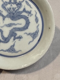 A Chinese monochrome 'anhua' 'dragon' bowl and a blue and white 'dragon' saucer, 18/19th C.