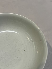 A Chinese monochrome 'anhua' 'dragon' bowl and a blue and white 'dragon' saucer, 18/19th C.